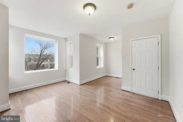 a view of a hallway with wooden floor