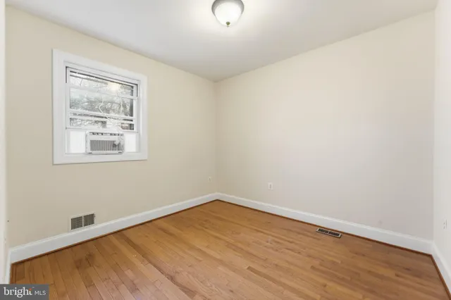 a view of a room with wooden floor and glass doors