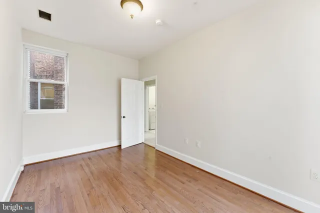 a view of a room with wooden floor and window