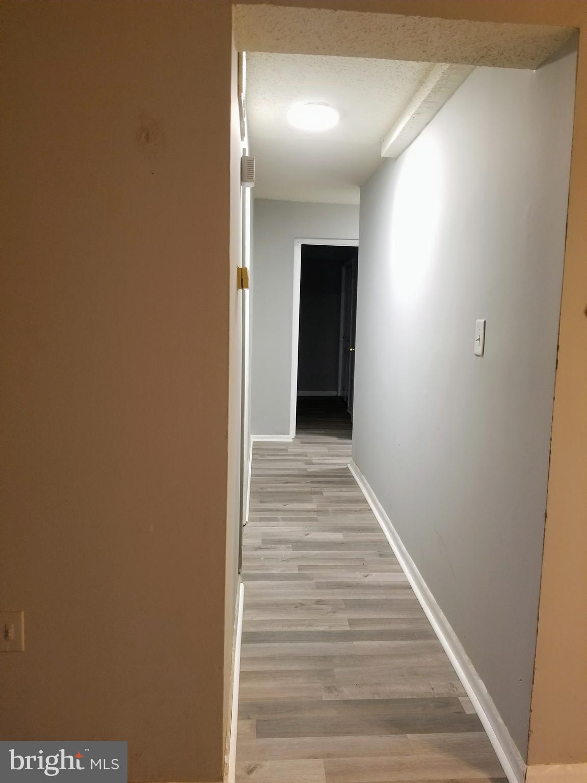 3807 Swann Road, Unit T1 Suitland, MD 20746 - Photo 3 of 8 a view of a hallway with wooden floor