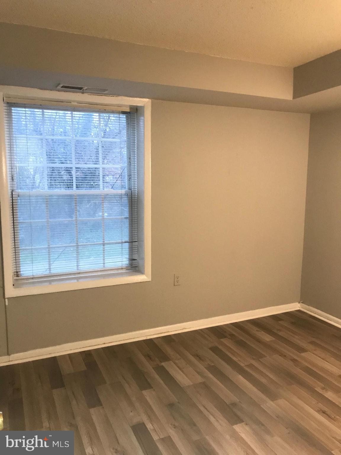 3807 Swann Road, Unit T1 Suitland, MD 20746 - Photo 6 of 8 a view of a small space with wooden floor and a window