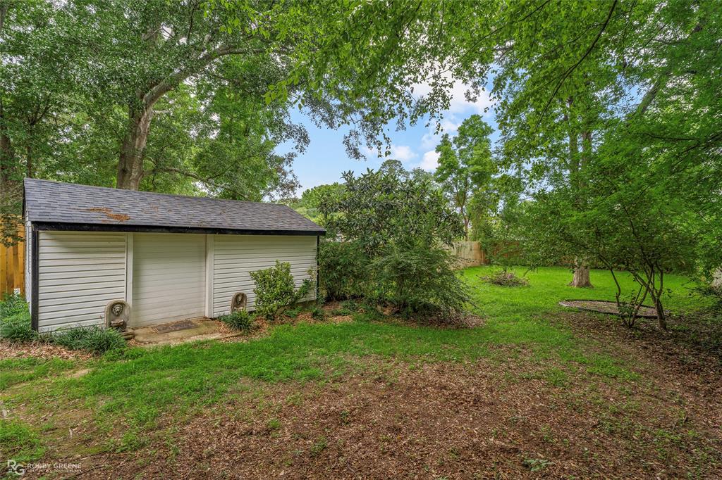 515 Davis Street Minden, LA 71055 - Photo 24 of 28 a backyard of a house with plants and large tree