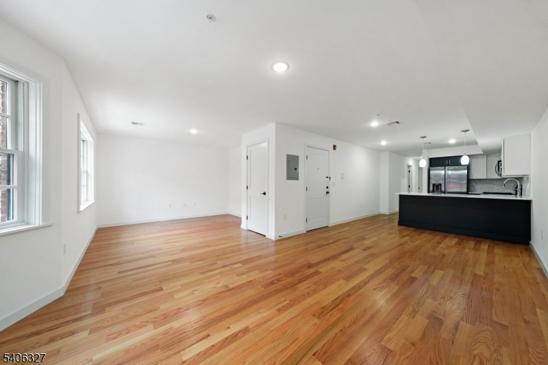 52 James Street, Unit 2 Newark, NJ 07102 - Photo 4 of 27 a view of kitchen and empty room with wooden floor