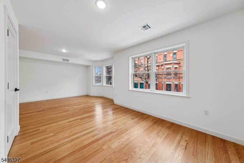 52 James Street, Unit 2 Newark, NJ 07102 - Photo 6 of 27 wooden floor in an empty room with a window
