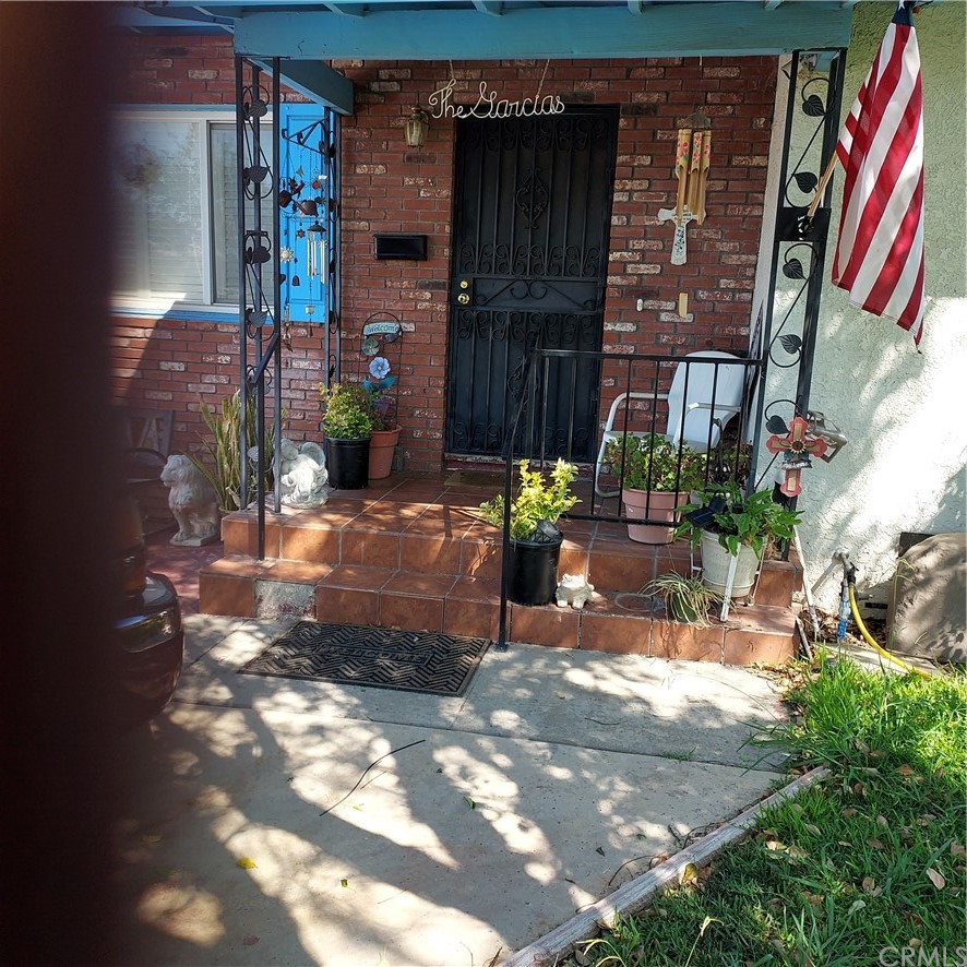 a view of backyard with a table and chairs and potted plants