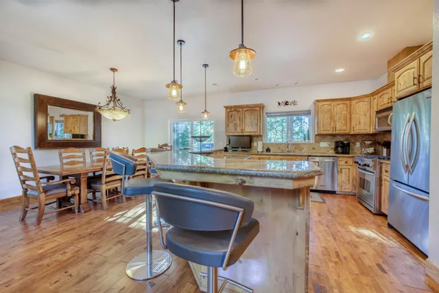 a view of a dining room with furniture wooden floor and chandelier