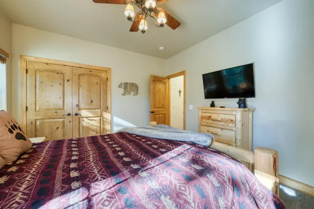 a bedroom with a bed and a large window with the outer view