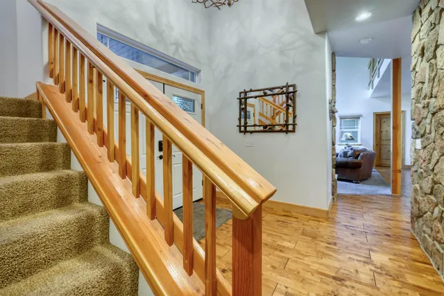a spacious bedroom with a bed and a chandelier
