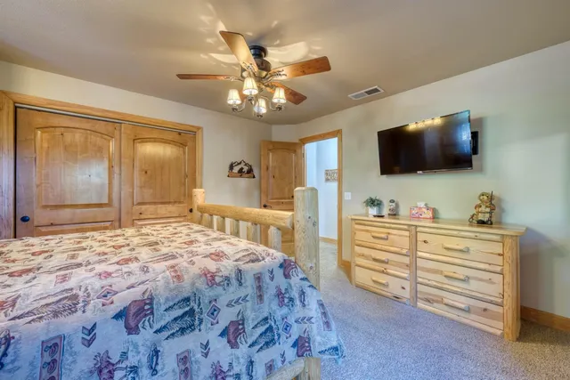 a balcony with wooden floor and trees in the back