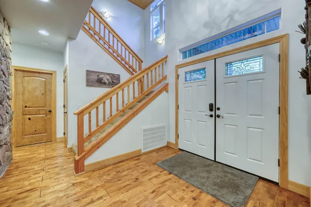 a living room with furniture and large windows