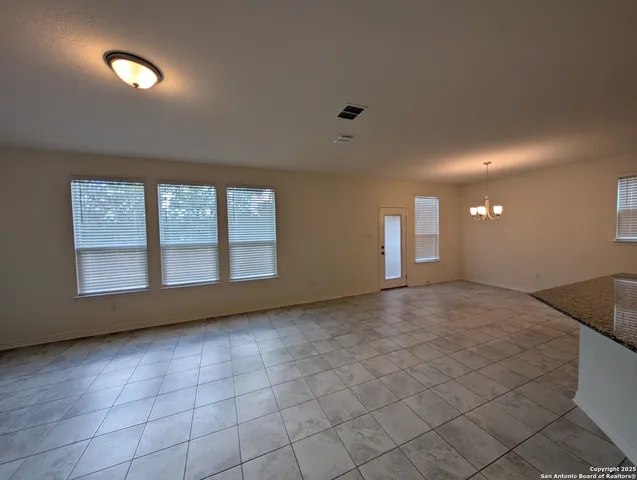 a large kitchen with granite countertop a large counter top stainless steel appliances and cabinets