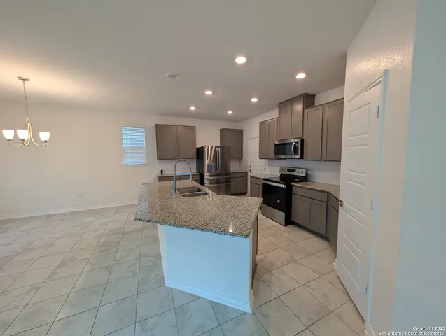 a kitchen with refrigerator and cabinets