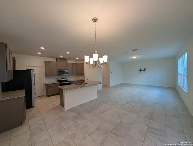 a kitchen with granite countertop a stove microwave and sink