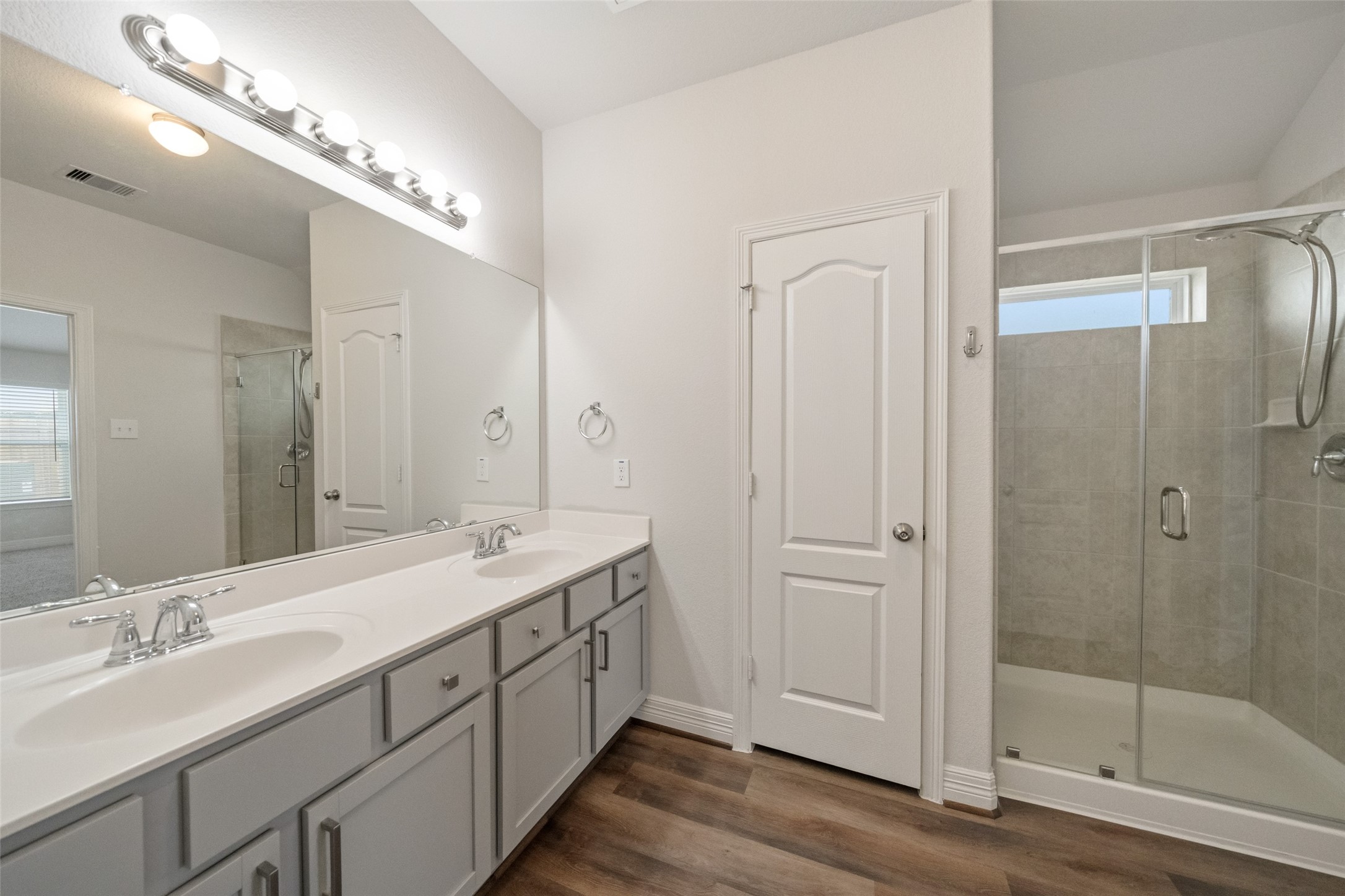 22642 Rosebush Hl Road Tomball, TX 77377 - Photo 17 of 27 a spacious bathroom with a double vanity sink and a mirror