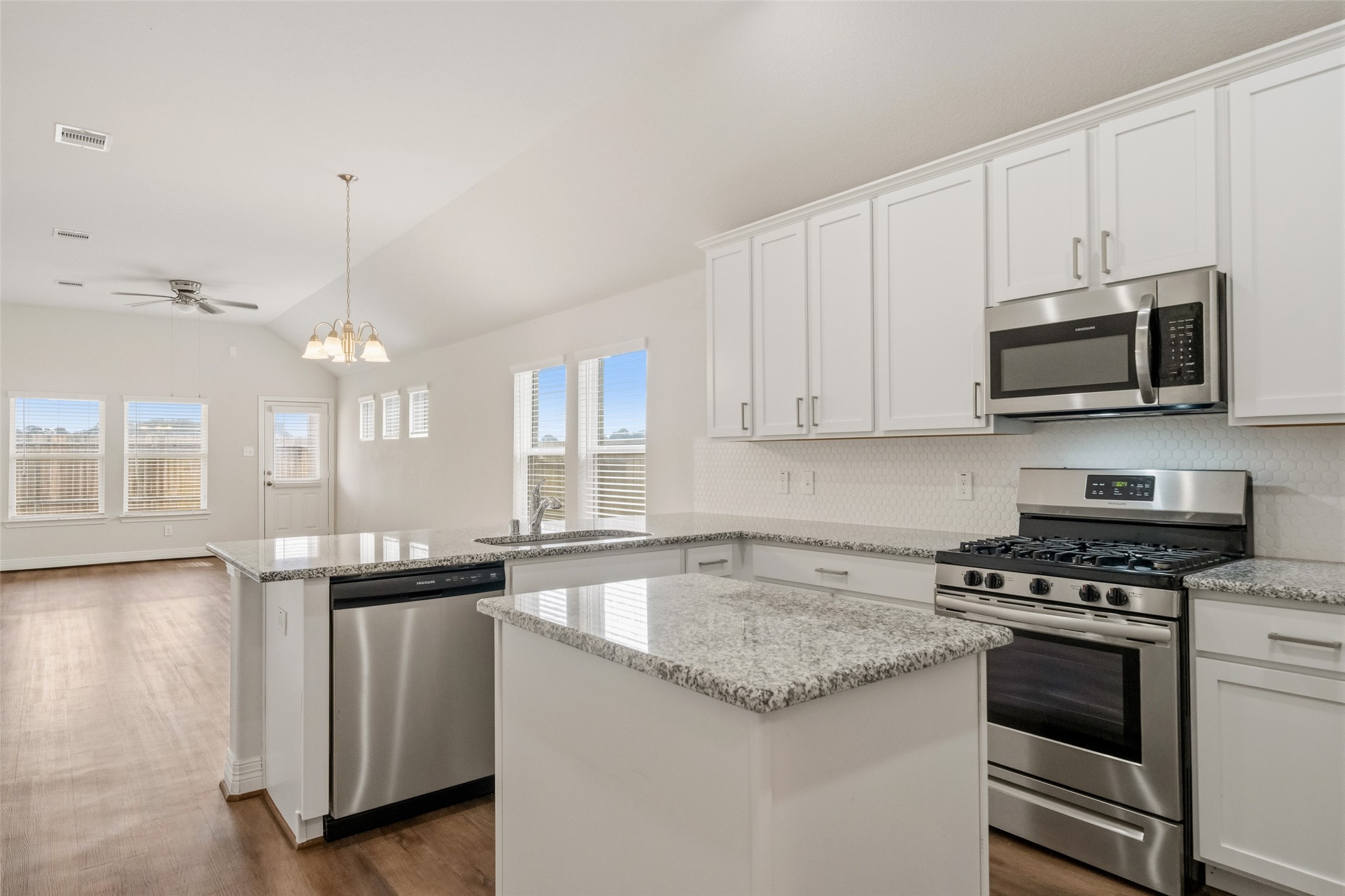 22642 Rosebush Hl Road Tomball, TX 77377 - Photo 3 of 27 a kitchen with granite countertop a sink a stove and cabinets