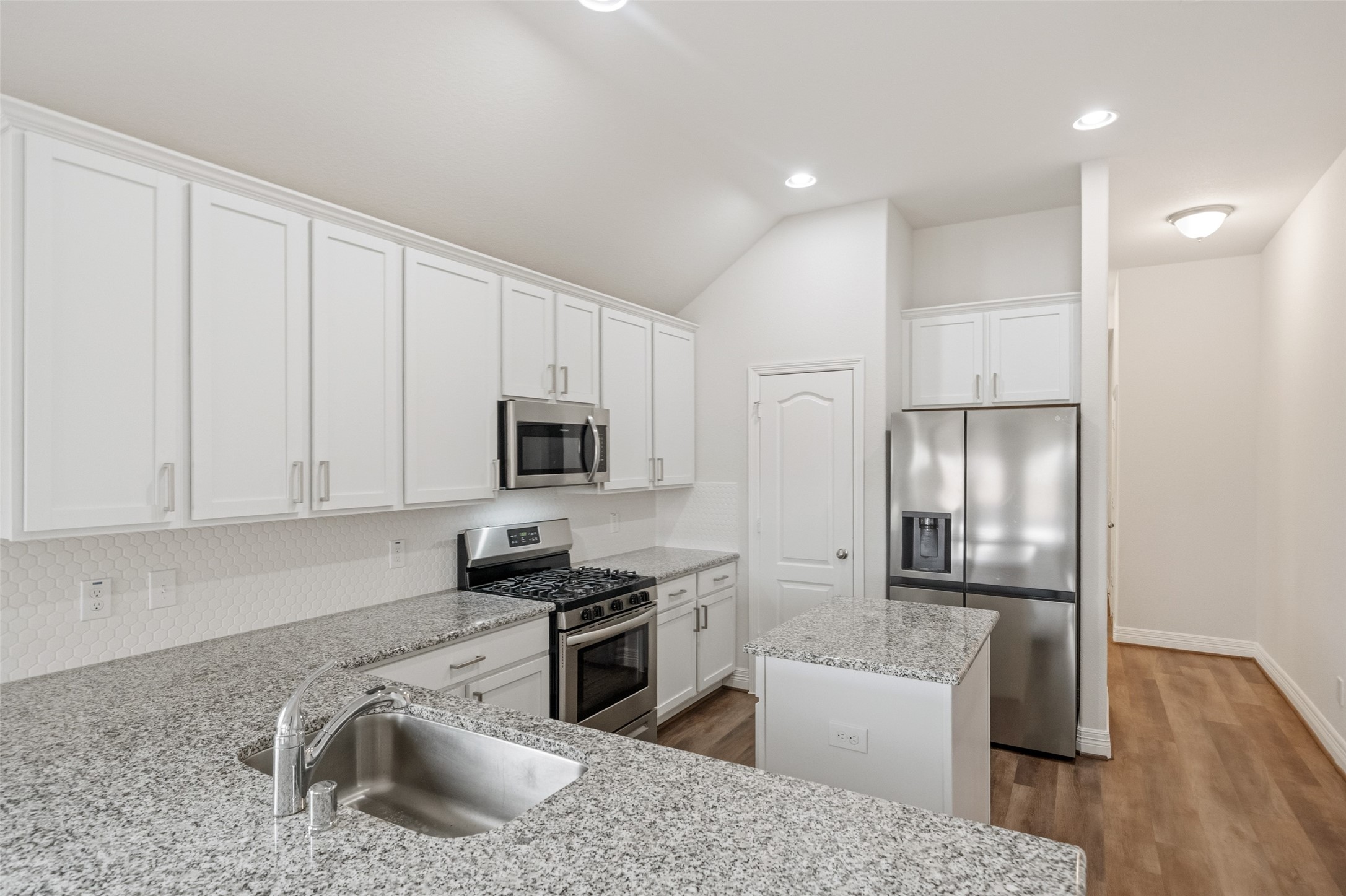 22642 Rosebush Hl Road Tomball, TX 77377 - Photo 5 of 27 a kitchen with granite countertop a refrigerator stove and sink