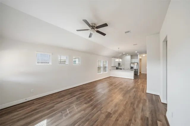 a view of empty room with wooden floor