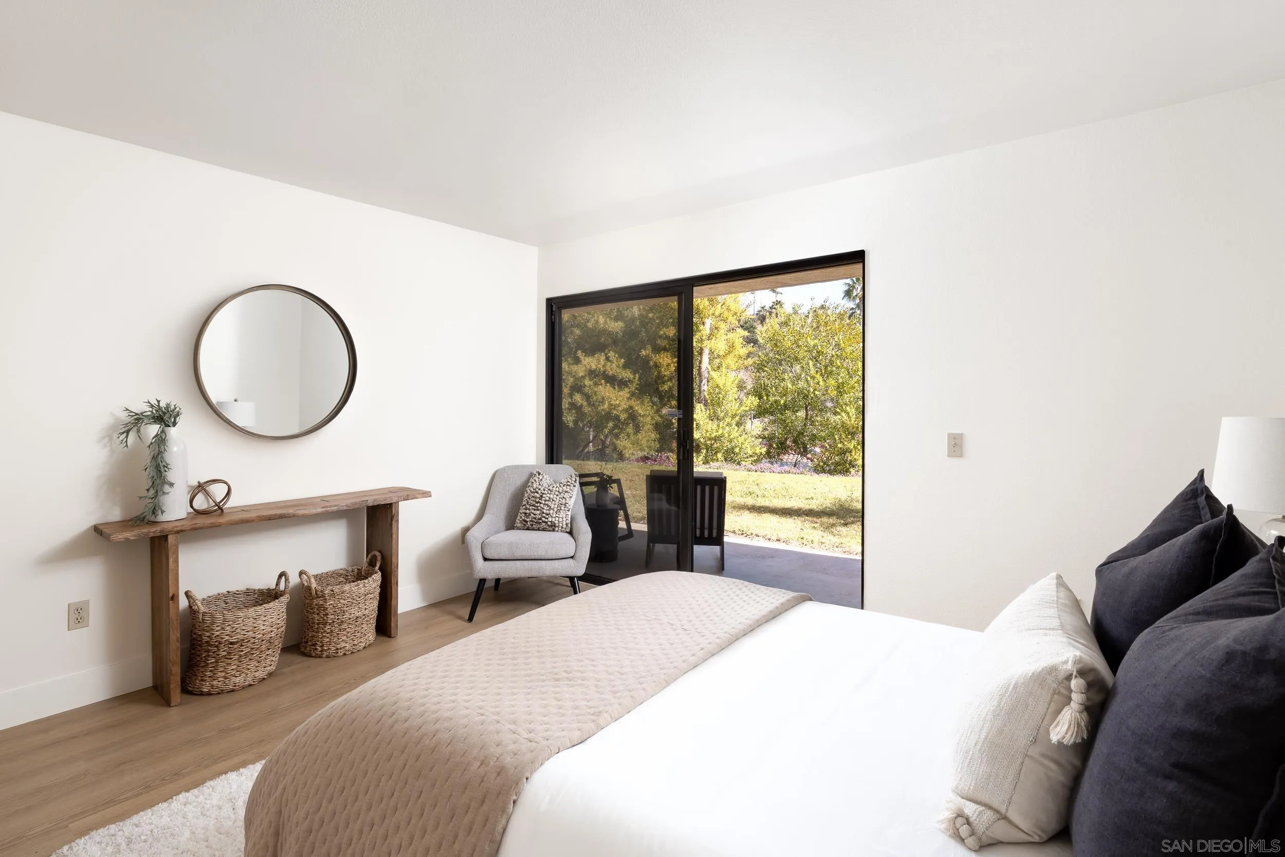7306 Alta Vista Carlsbad, CA 92009 - Photo 11 of 22 a bedroom with a bed a mirror and a large window with outer view