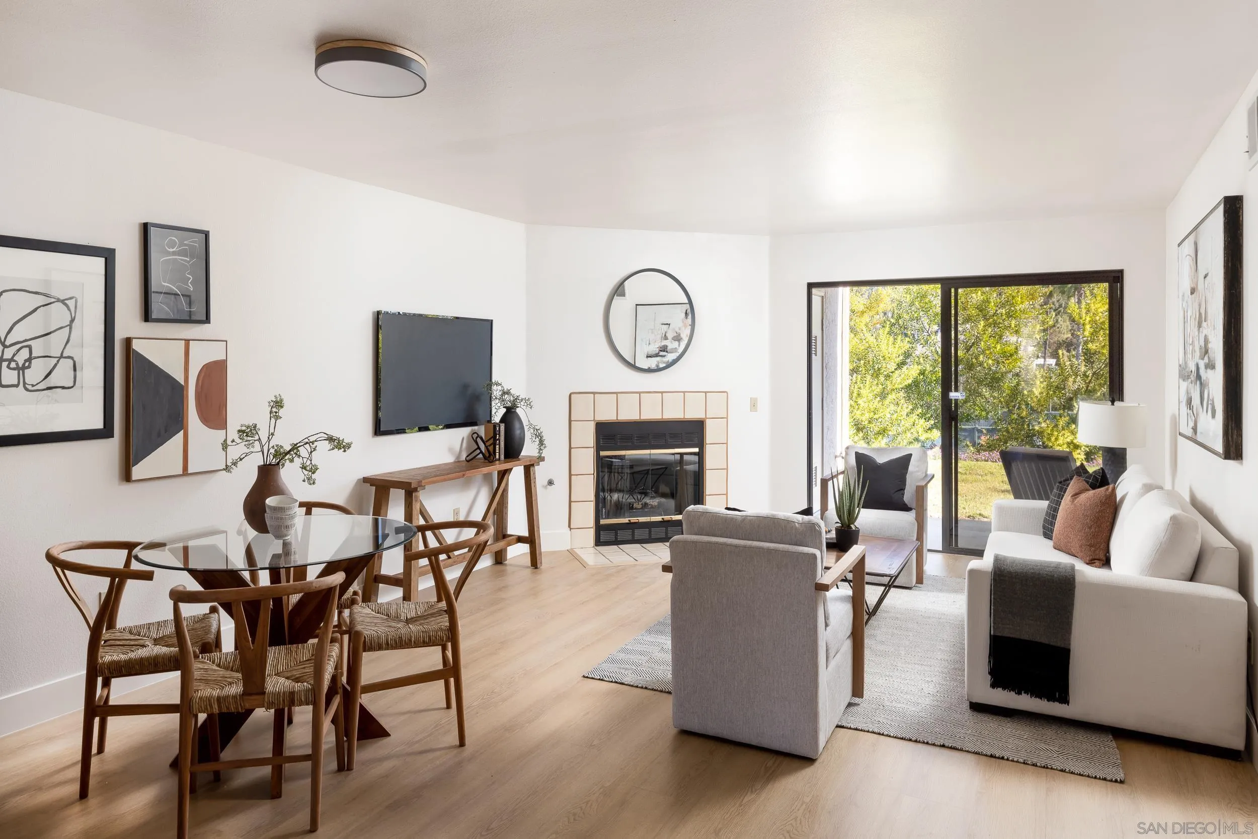 7306 Alta Vista Carlsbad, CA 92009 - Photo 4 of 22 a living room with furniture a fireplace and a large window