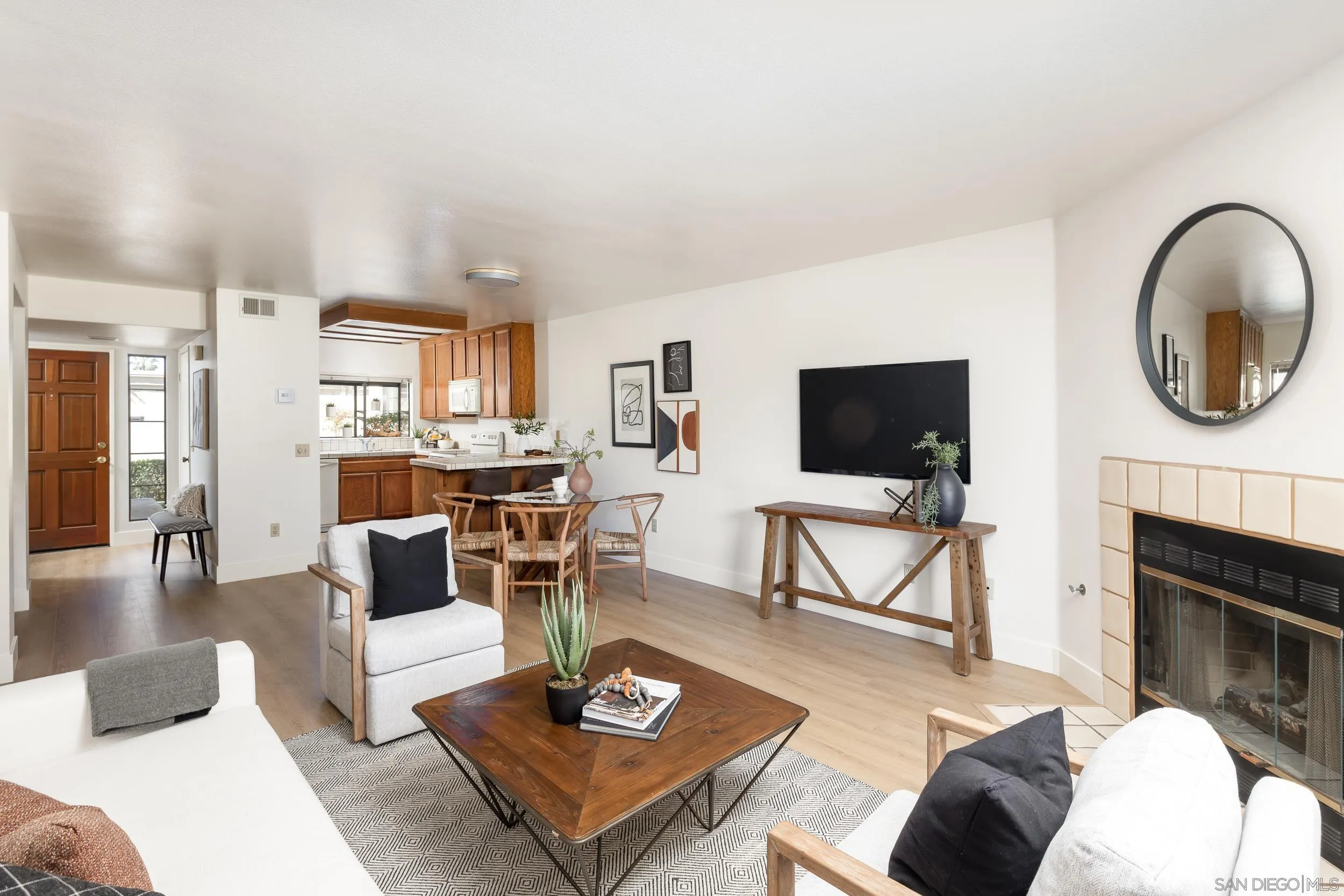 7306 Alta Vista Carlsbad, CA 92009 - Photo 5 of 22 a living room with furniture a flat screen tv and a fireplace