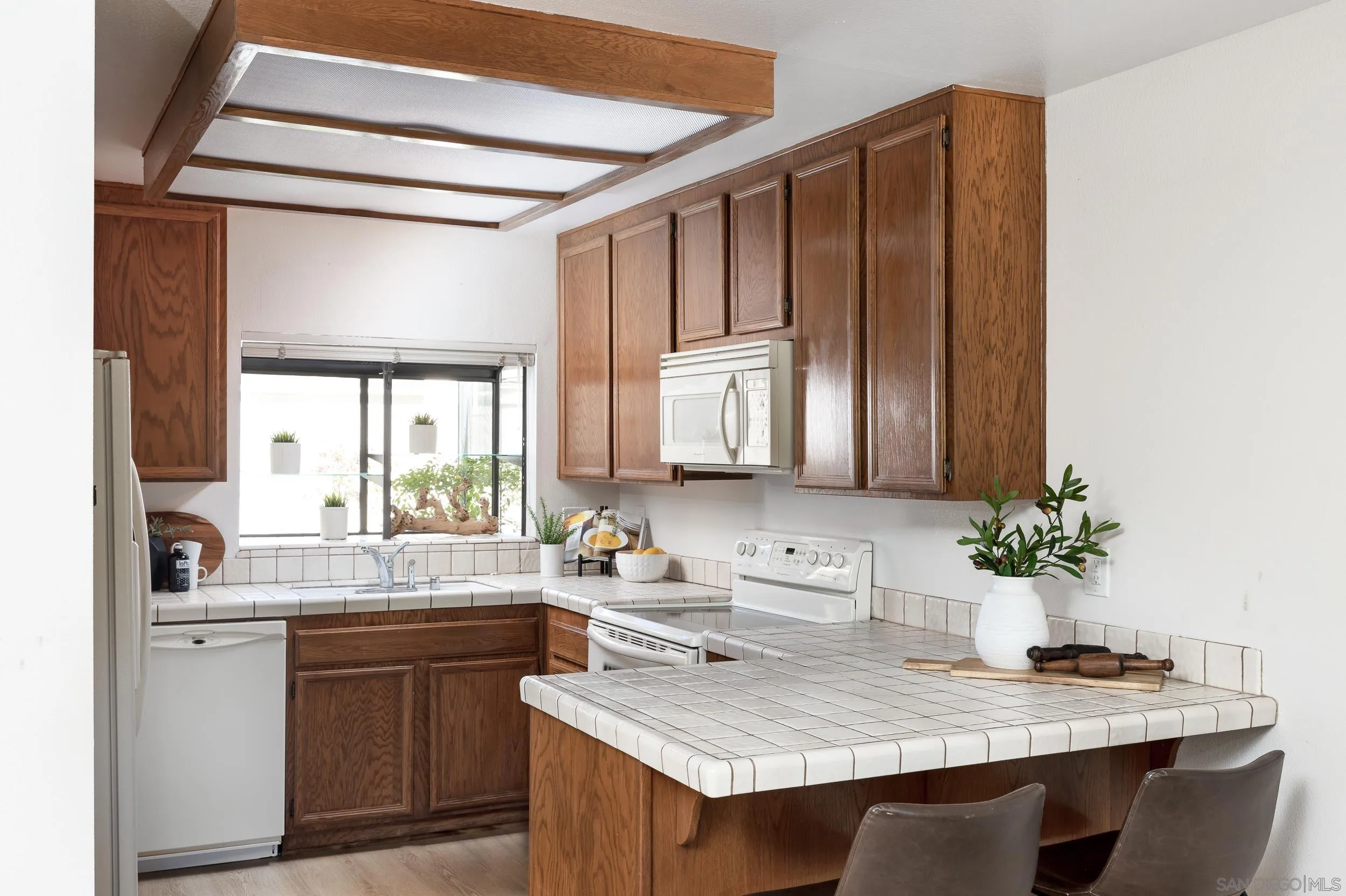 7306 Alta Vista Carlsbad, CA 92009 - Photo 7 of 22 a kitchen with a sink cabinets and window
