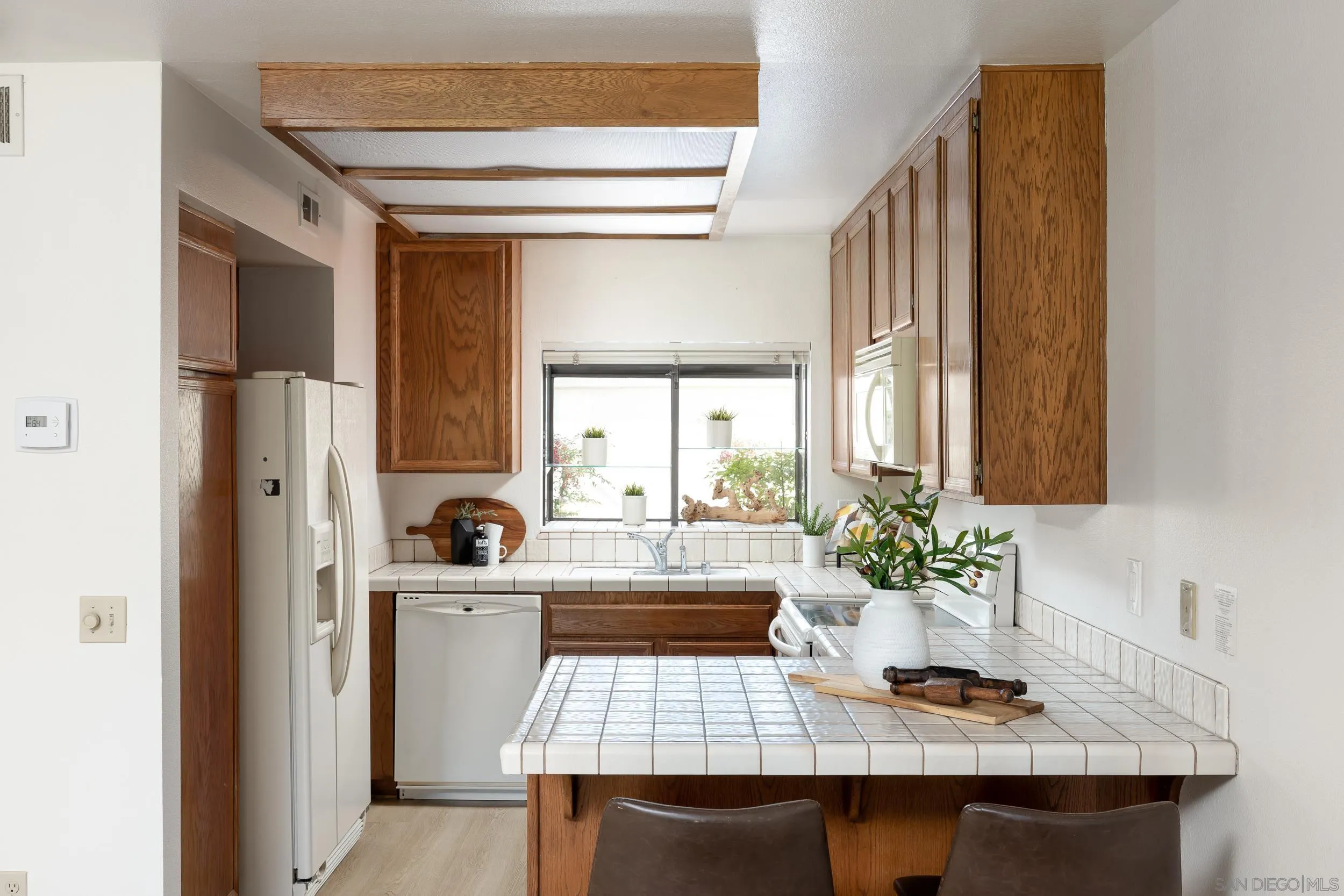 7306 Alta Vista Carlsbad, CA 92009 - Photo 8 of 22 a kitchen with a sink and a refrigerator