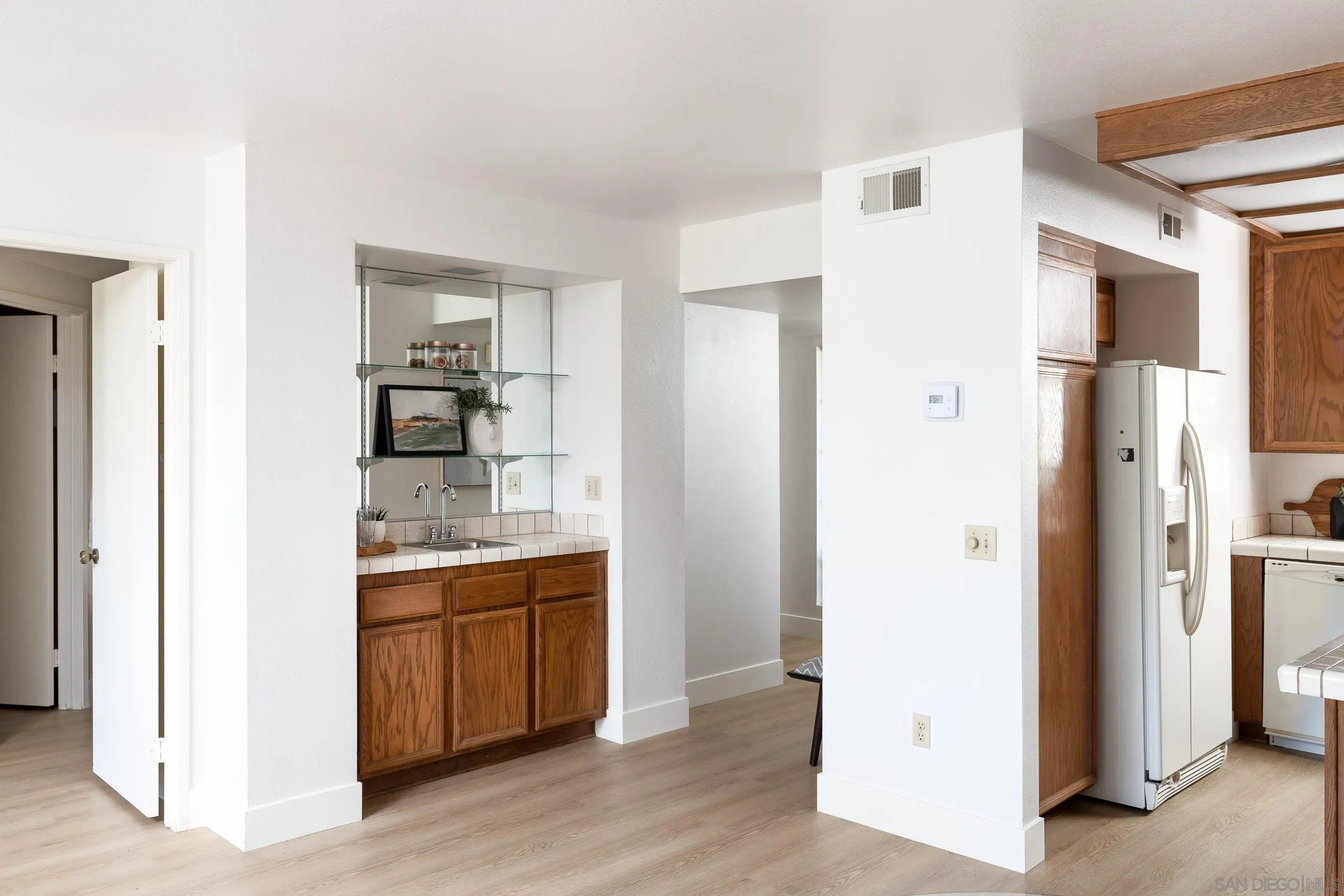 7306 Alta Vista Carlsbad, CA 92009 - Photo 9 of 22 a kitchen with stainless steel appliances a refrigerator and cabinets
