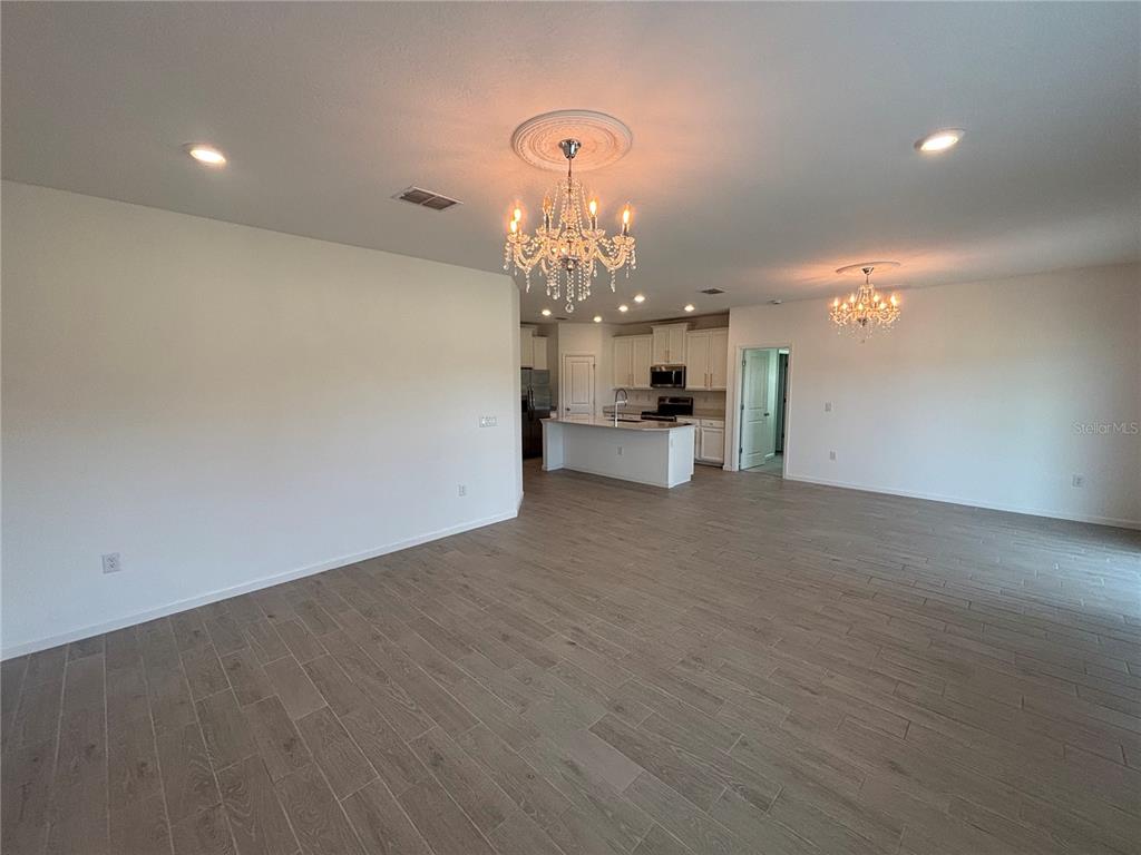 9145 Southwest 58th Circle Ocala, FL 34476 - Photo 13 of 37 a view of a chandelier in big room and chandelier fan