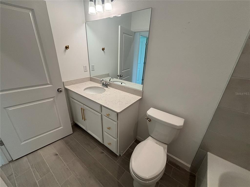 9145 Southwest 58th Circle Ocala, FL 34476 - Photo 16 of 37 a bathroom with a toilet sink and mirror