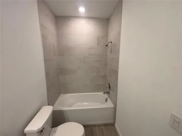 a bathroom with a toilet and bathtub