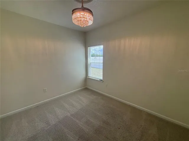 an empty room with a fan