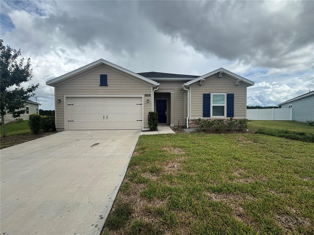 9145 Southwest 58th Circle Ocala, FL 34476 - Photo 2 of 37 a view of a house with a yard