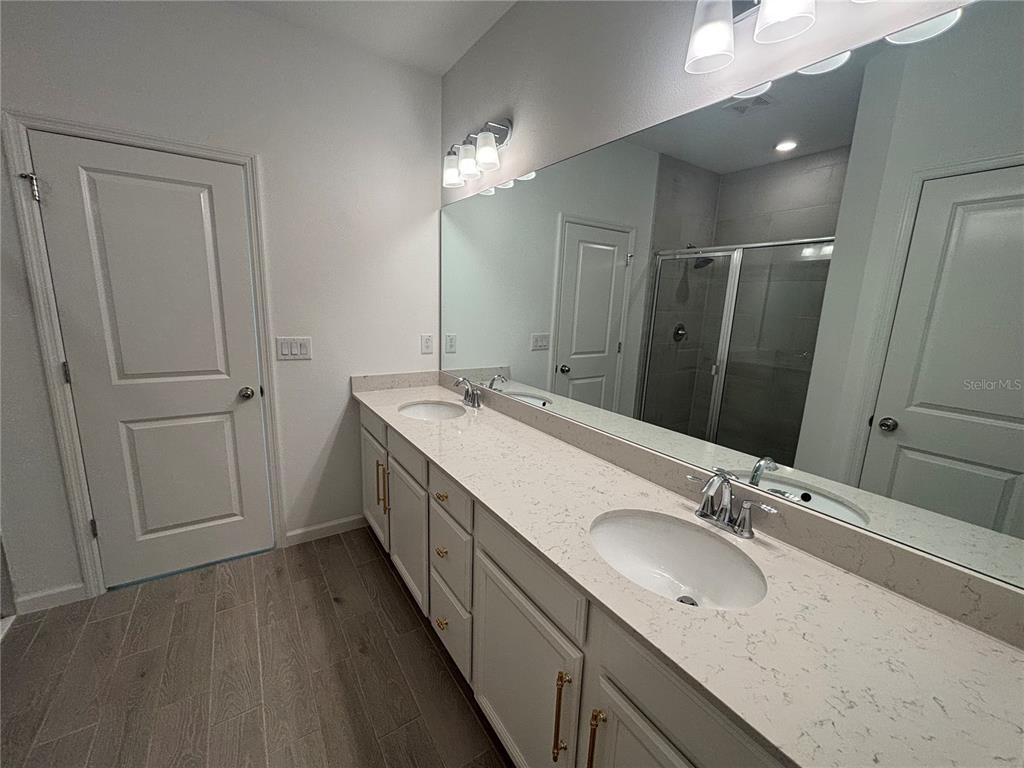9145 Southwest 58th Circle Ocala, FL 34476 - Photo 23 of 37 a bathroom with double vanity sink and a mirror