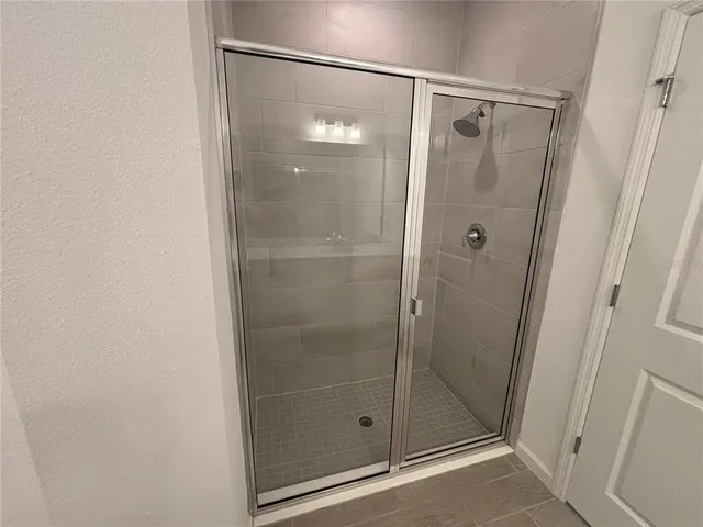 a bathroom with a glass shower door