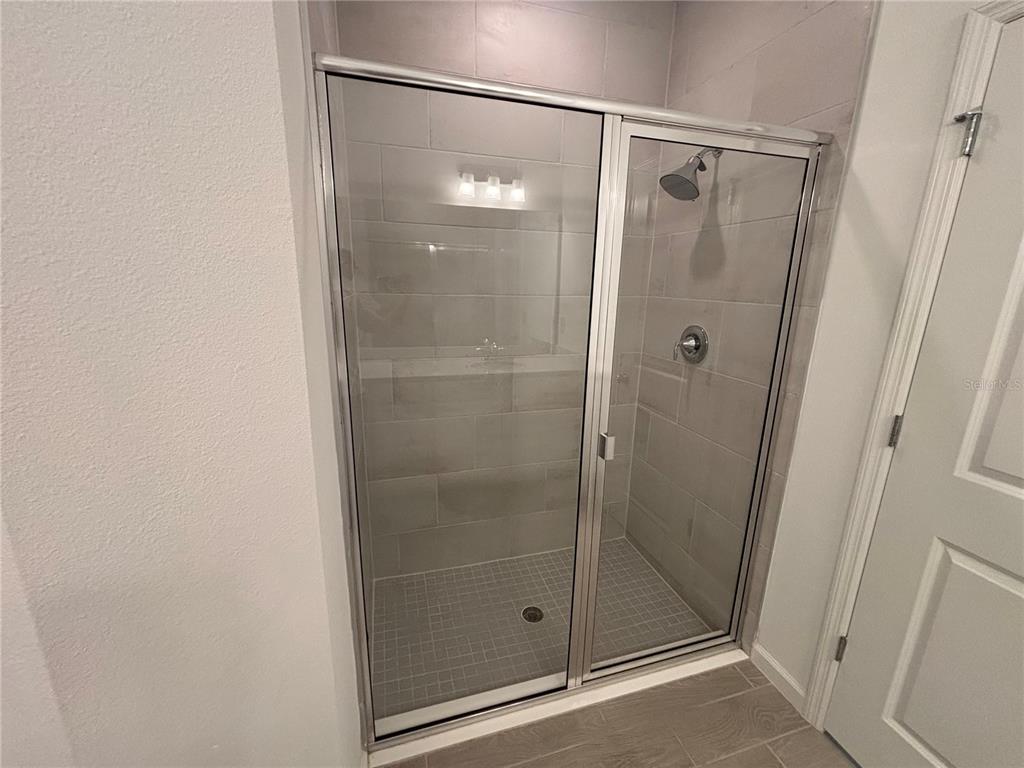 9145 Southwest 58th Circle Ocala, FL 34476 - Photo 24 of 37 a bathroom with a glass shower door