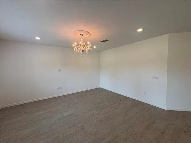 a view of an empty room with a chandelier
