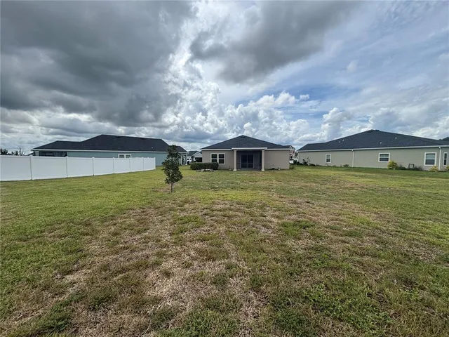 an outdoor space with pool and trees
