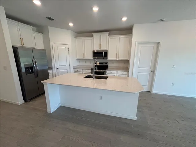 a kitchen with refrigerator and window