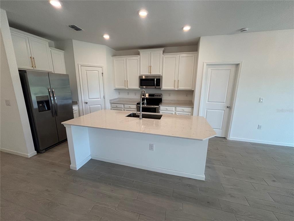 9145 Southwest 58th Circle Ocala, FL 34476 - Photo 5 of 37 a kitchen with refrigerator and window