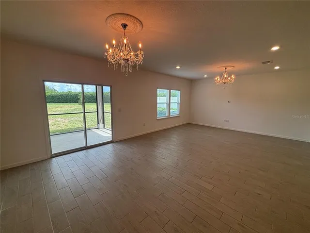 a view of a livingroom with a fan a fireplace and wooden floor