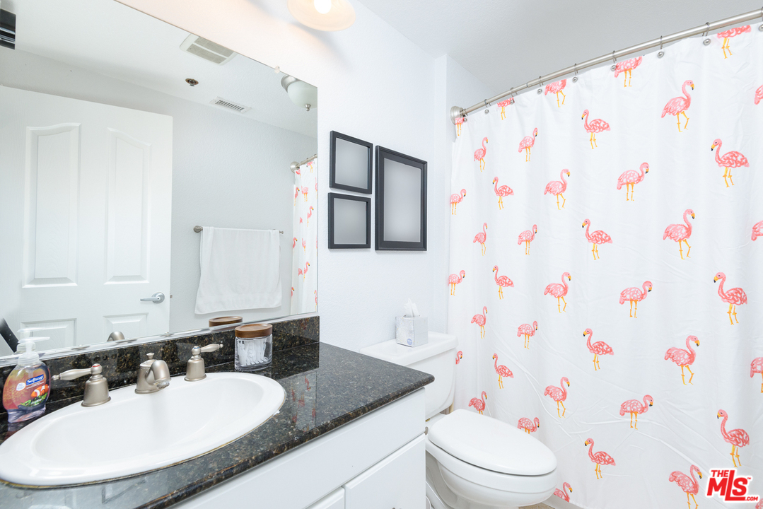 838 Pine Avenue, Unit 216 Long Beach, CA 90813 - Photo 16 of 35 a bathroom with a sink toilet and a mirror