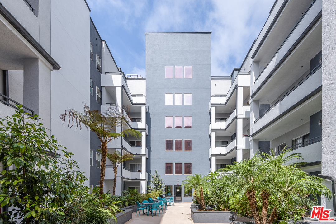 838 Pine Avenue, Unit 216 Long Beach, CA 90813 - Photo 28 of 35 a front view of multi story residential apartment building with yard