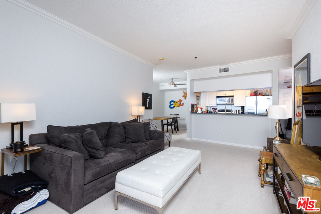 838 Pine Avenue, Unit 216 Long Beach, CA 90813 - Photo 8 of 35 a living room with furniture and a flat screen tv