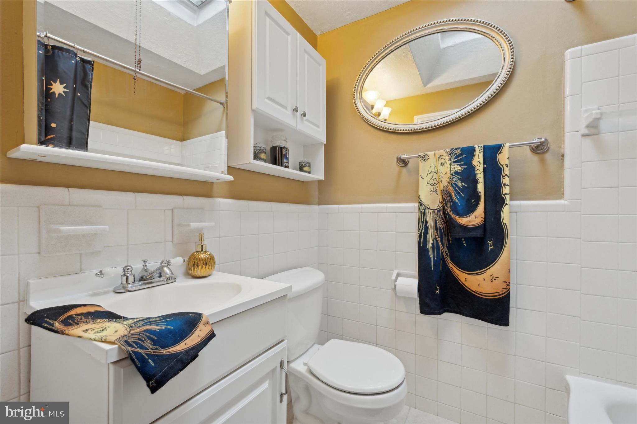 5229 North Springfield Road Clifton Heights, PA 19018 - Photo 17 of 25 a bathroom with a toilet a sink and a mirror
