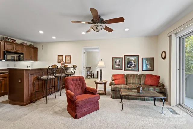 a living room with furniture kitchen and a window