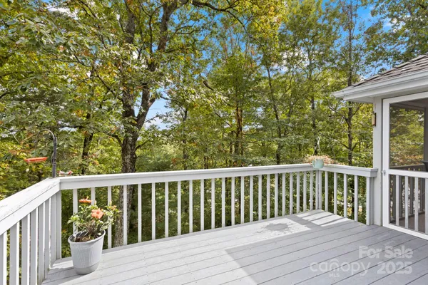 a balcony with wooden floor and fence