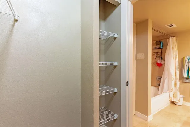 a bathroom with a shower and a sink
