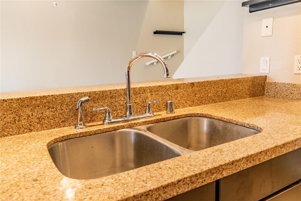 4777 Cedar Springs Road, Unit 8J Dallas, TX 75219 - Photo 17 of 30 a kitchen with a sink and a stove