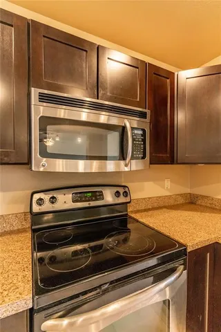 a stove top oven sitting inside of a kitchen