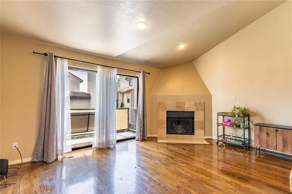 a view of a livingroom with a fireplace and wooden floor